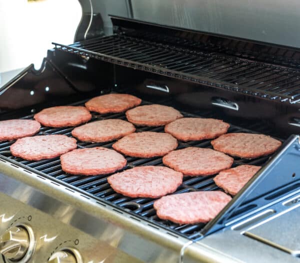 Frozen Beef burgers on grill