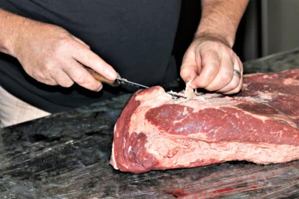 Trimming fat off brisket