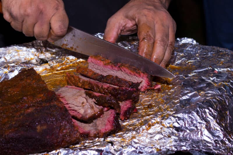 Man slicing smoked brisket