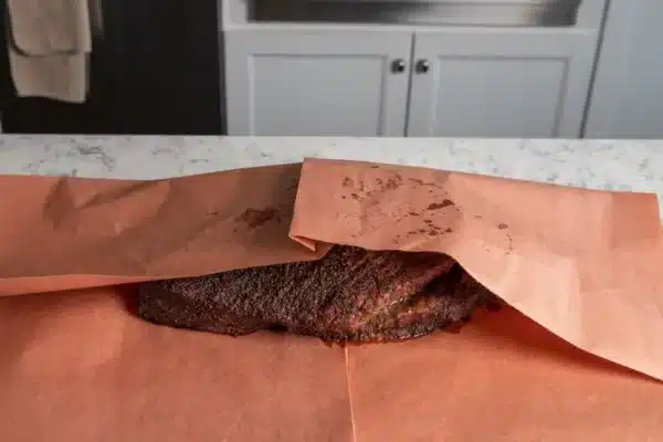 First brisket— wrapped in butcher paper at 170, just pulled off the smoker  at 203. Now tightly wrapped in foil and towels in a cooler. Can't wait to  see how it tastes! 