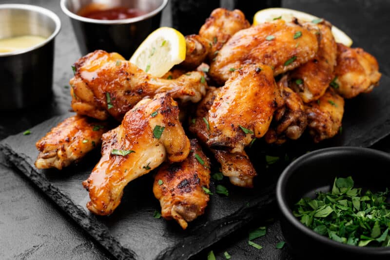Baked,Chicken,Wings,Served,With,Different,Sauces,And,Lemon.,Black