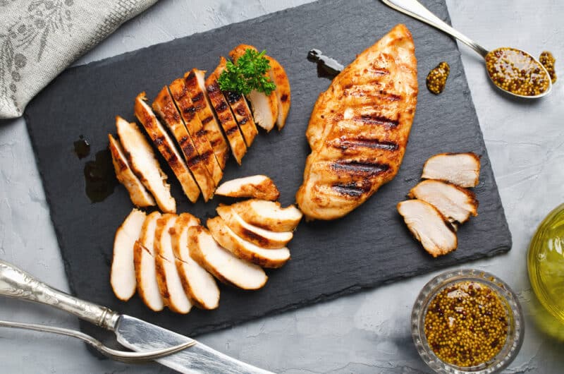 Grilled,Chicken,Fillets,On,Slate,Plate.,Gray,Concrete,Background