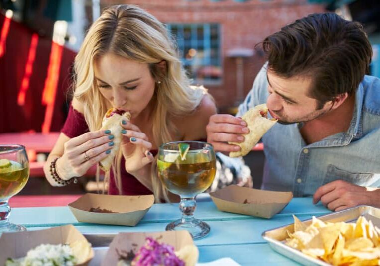 Romantic,Couple,Eating,Street,Tacos,At,Outdoor,Mexican,Restaurant