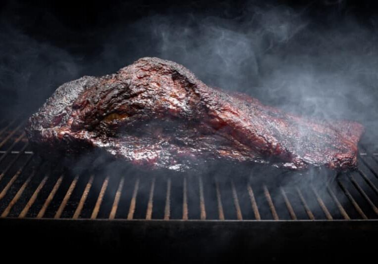 Smoke,Rising,Around,A,Slow,Cooked,Beef,Brisket,On,The