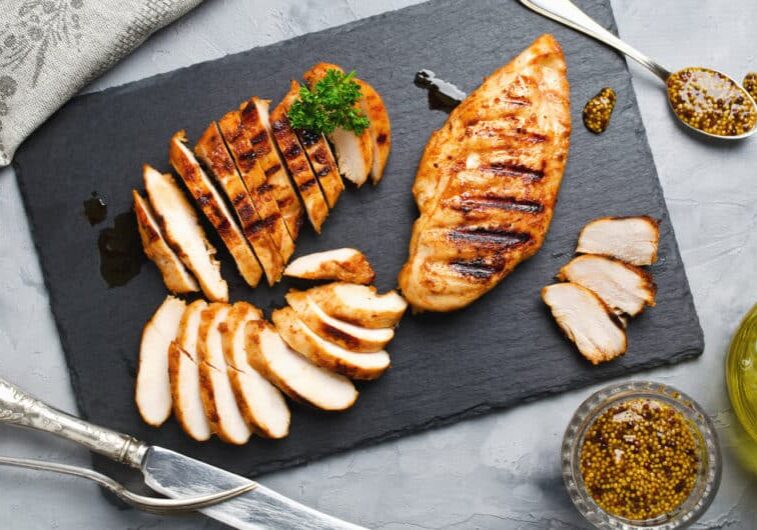 Grilled,Chicken,Fillets,On,Slate,Plate.,Gray,Concrete,Background
